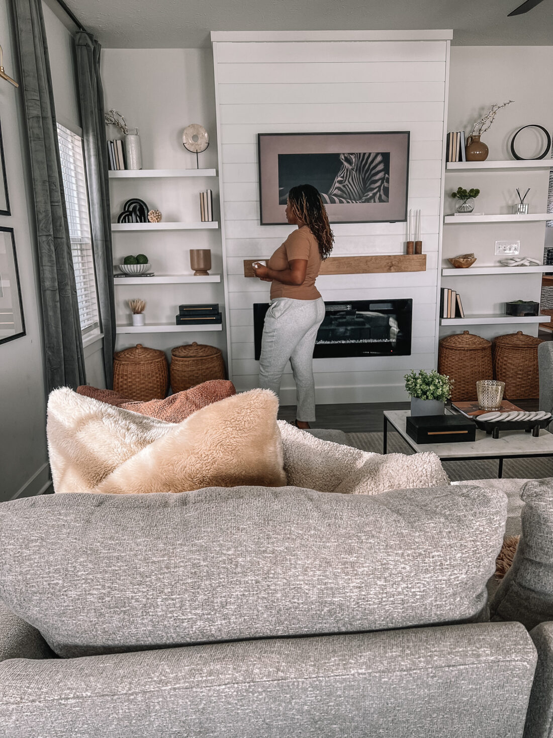 tasha next to shelves